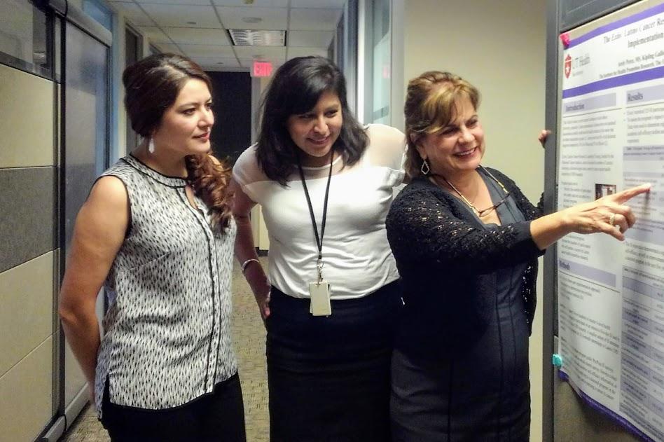 Doctoral candidate Rosalie Aguilar discusses the Éxito! Latino Cancer Research Leadership Training program with program coordinator Arely Perez and director Amelie Ramirez.